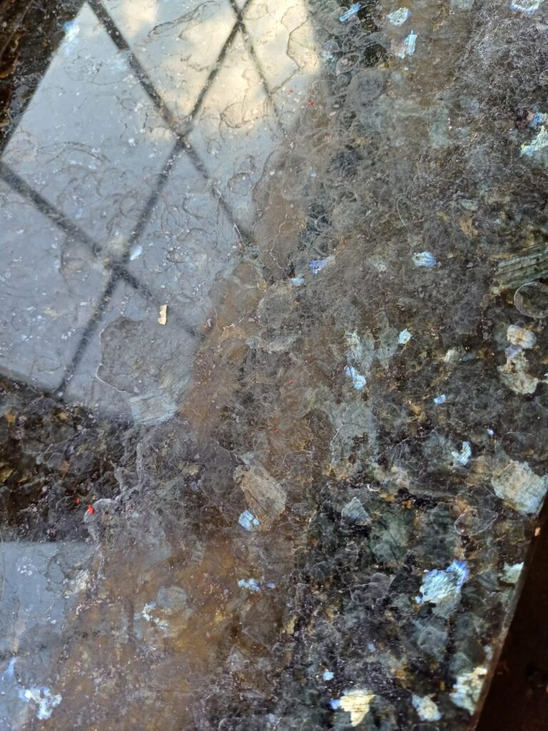 close up of granite and quartz work surface - before specialist cleaning