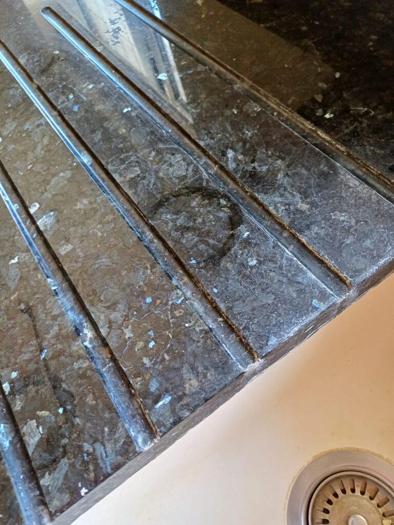 close up granite and quartz work surface showing stains - before specialist cleaning